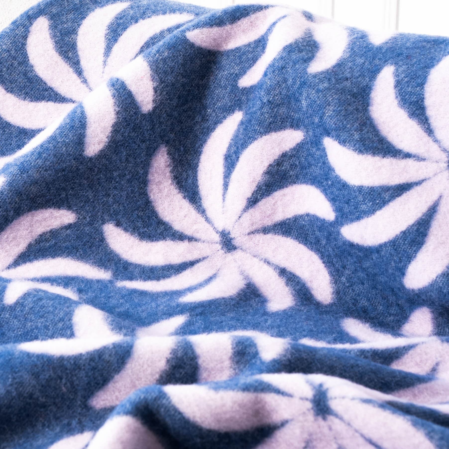 Texture detail of blue and lilac floral wool blanket – WOLIQ Coastal Bloom