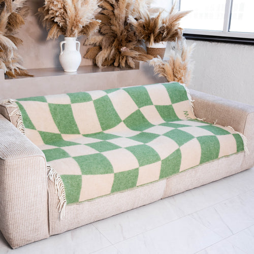 Green and beige cube illusion wool blanket on sofa – WOLIQ Gentle Shift