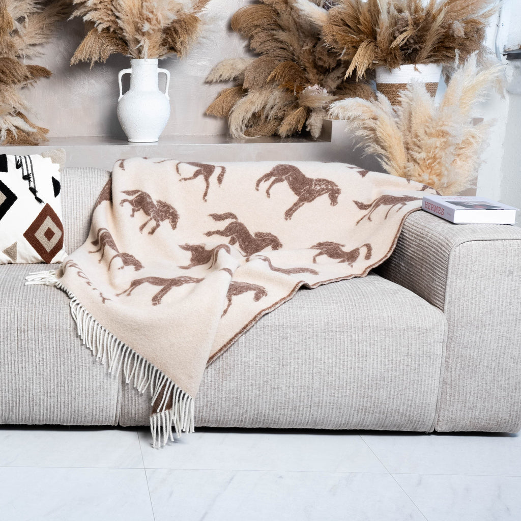 Brown horse pattern wool blanket draped on sofa – WOLIQ Gentle Wild