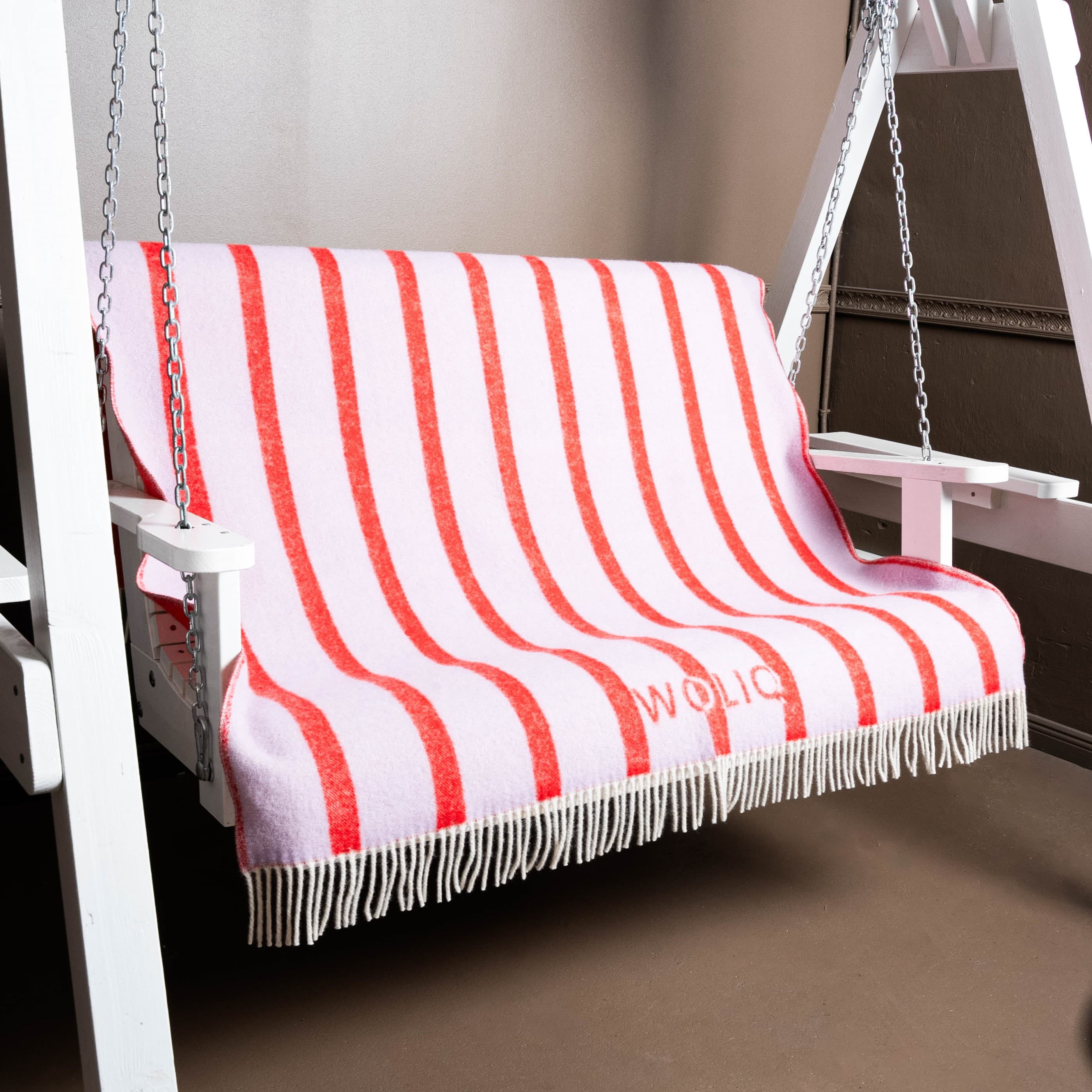 Pink and red striped wool blanket on swing – WOLIQ Hug Me