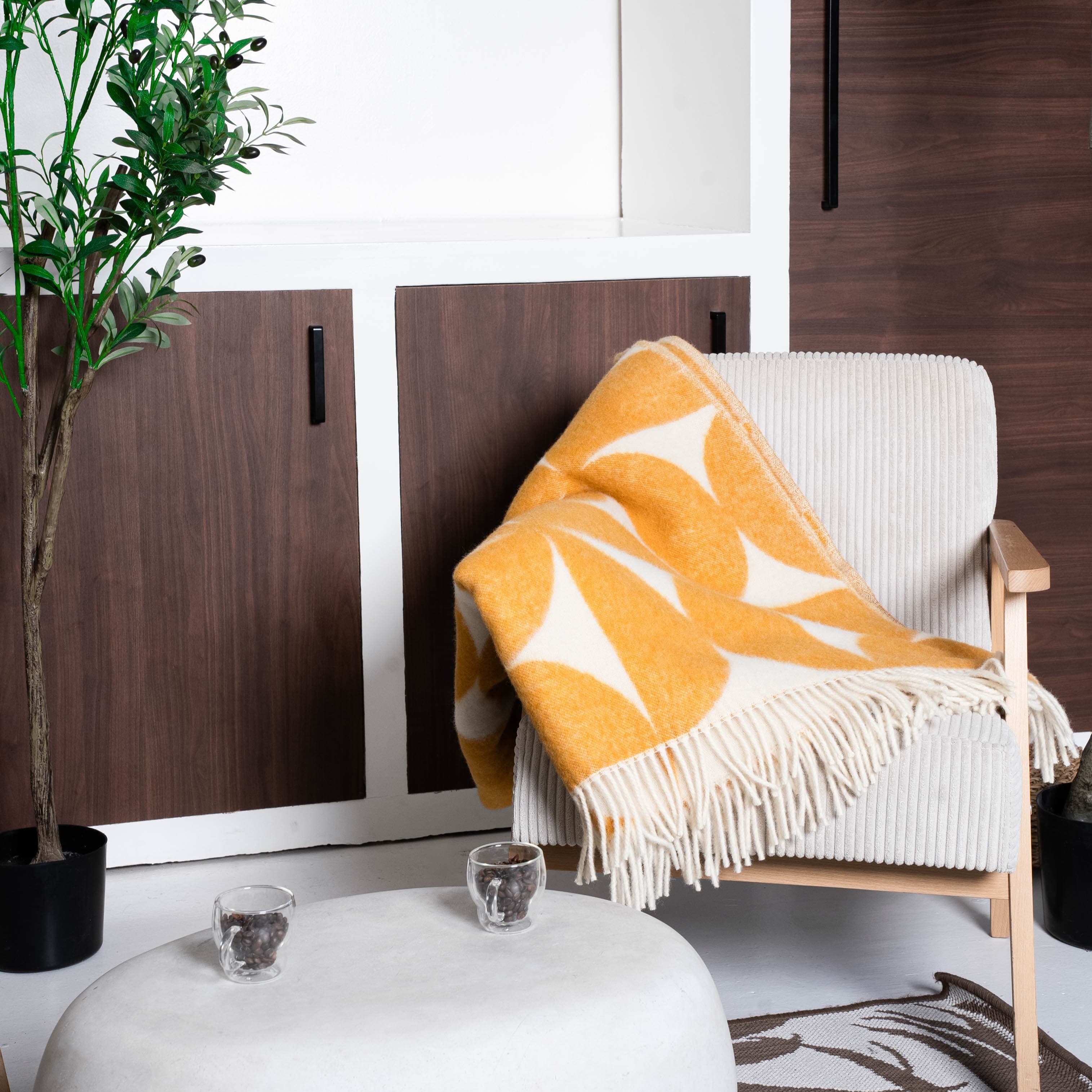 Yellow and white Bauhaus wool blanket draped over chair – WOLIQ Solar Bauhaus